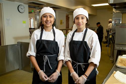 Two Students working in a Kitchen 
